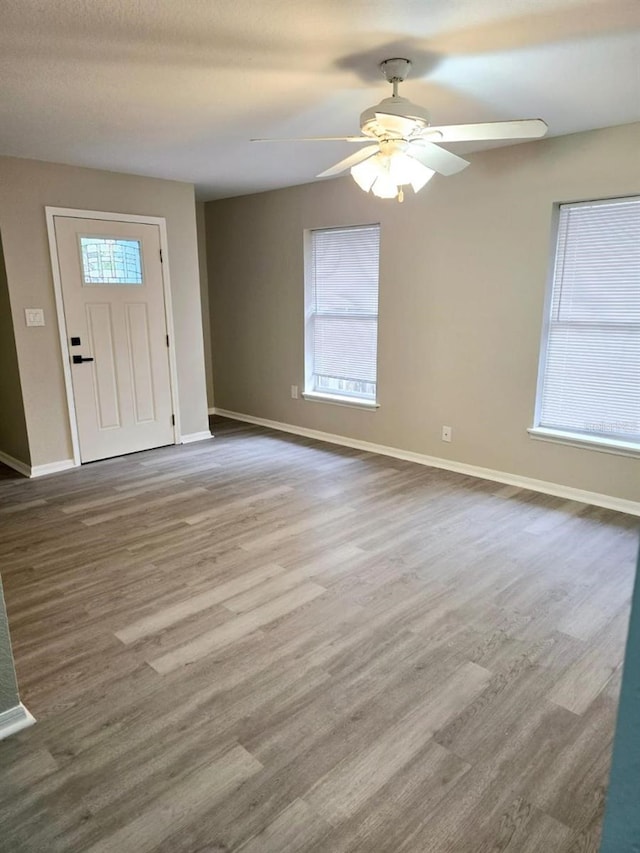 foyer entrance with a healthy amount of sunlight, hardwood / wood-style floors, and ceiling fan