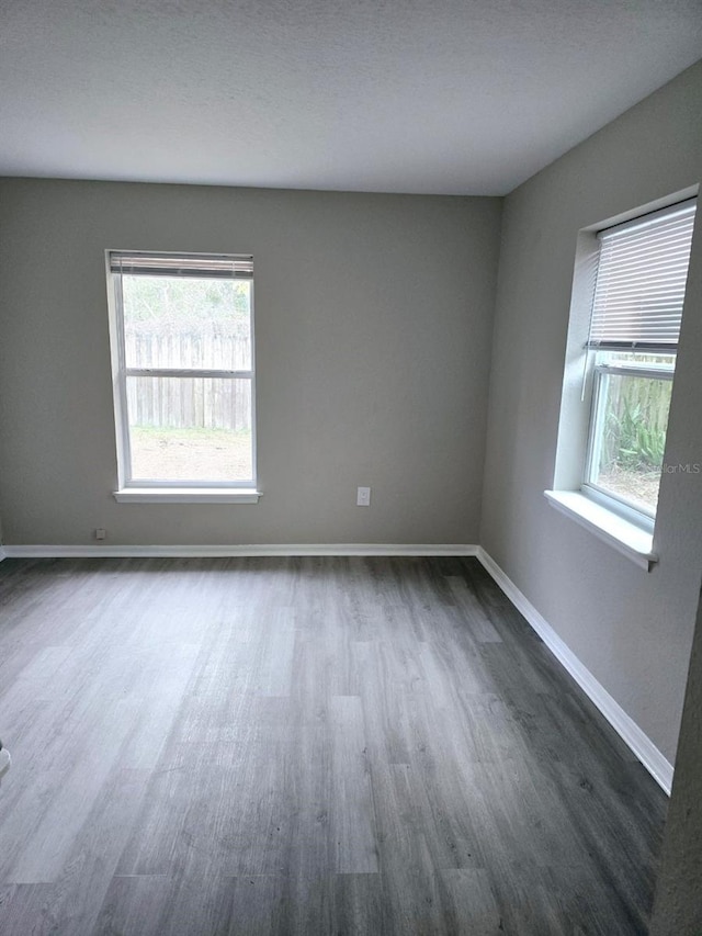 unfurnished room with dark hardwood / wood-style floors