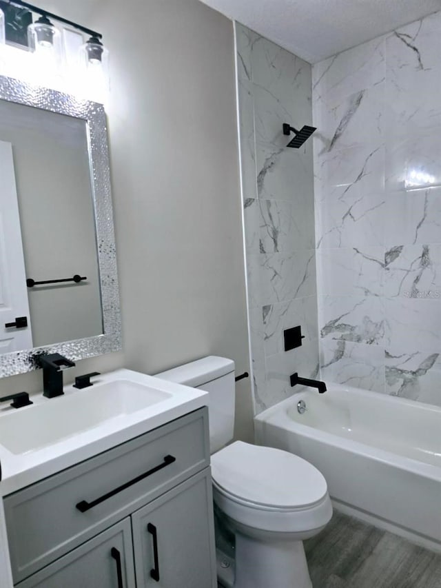 full bathroom featuring hardwood / wood-style flooring,  shower combination, toilet, and vanity