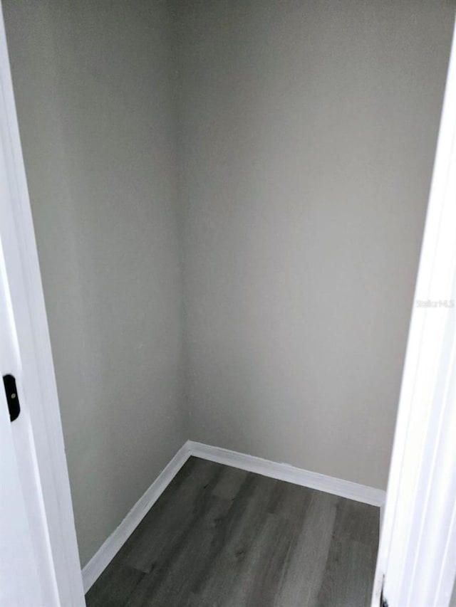 unfurnished room featuring dark hardwood / wood-style flooring