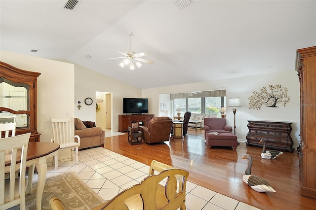 living room with lofted ceiling, light hardwood / wood-style floors, and ceiling fan