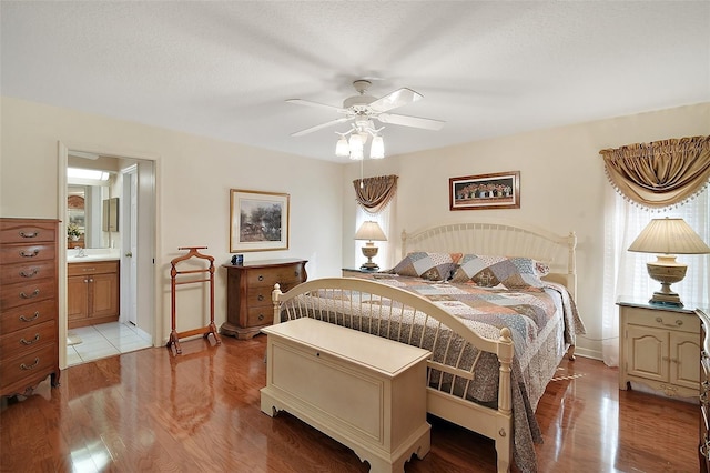 bedroom featuring multiple windows, ensuite bathroom, and light hardwood / wood-style floors