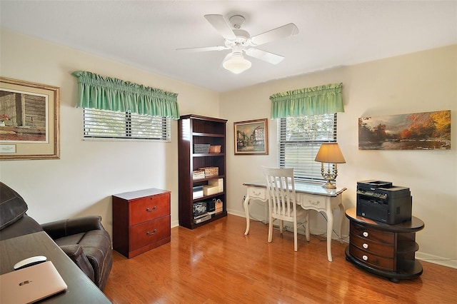 home office with wood-type flooring and ceiling fan