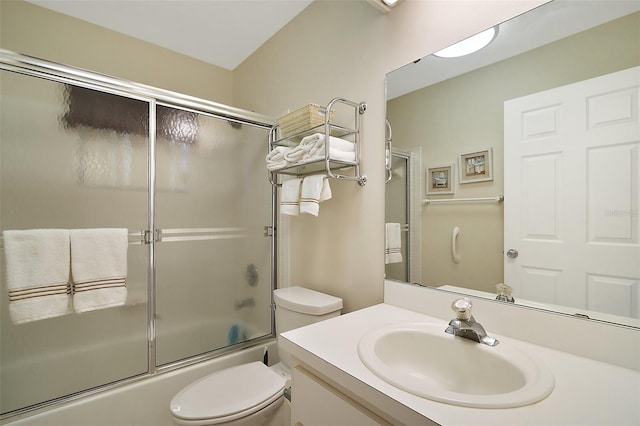 full bathroom with vanity, combined bath / shower with glass door, and toilet