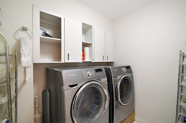 clothes washing area with washing machine and clothes dryer