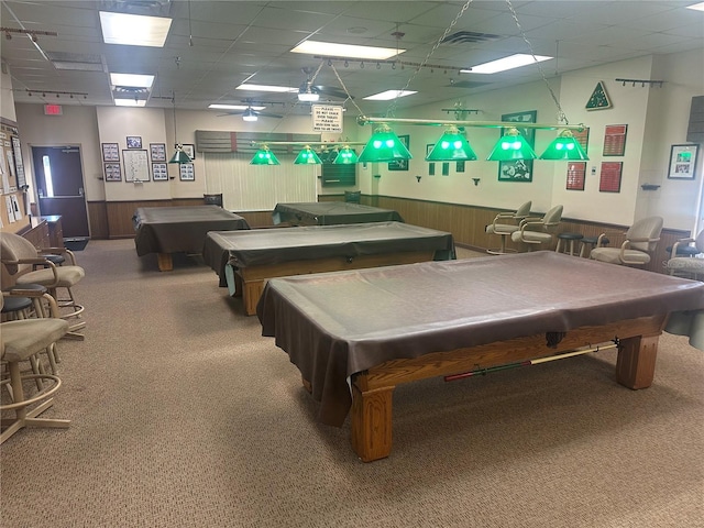 game room featuring pool table, a drop ceiling, and wooden walls