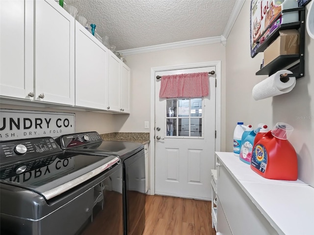 laundry area featuring cabinets, ornamental molding, separate washer and dryer, and a textured ceiling