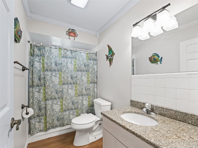 bathroom with hardwood / wood-style flooring, ornamental molding, vanity, toilet, and a textured ceiling