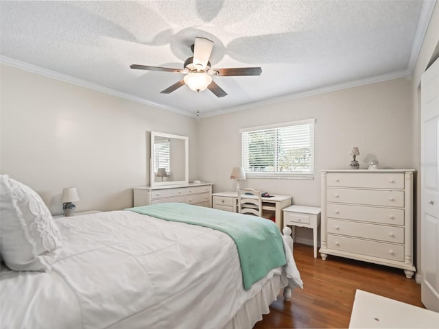 bedroom with ceiling fan, crown molding, dark wood-type flooring, and a textured ceiling