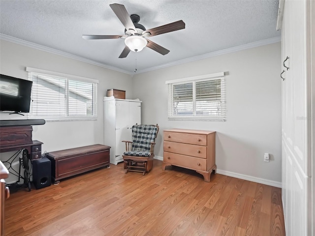 interior space with ceiling fan, ornamental molding, light hardwood / wood-style flooring, and a textured ceiling