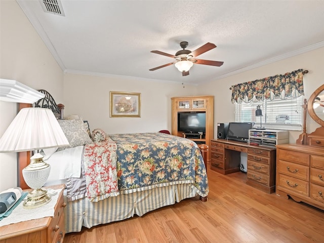 bedroom featuring crown molding, light hardwood / wood-style floors, ceiling fan, and a textured ceiling