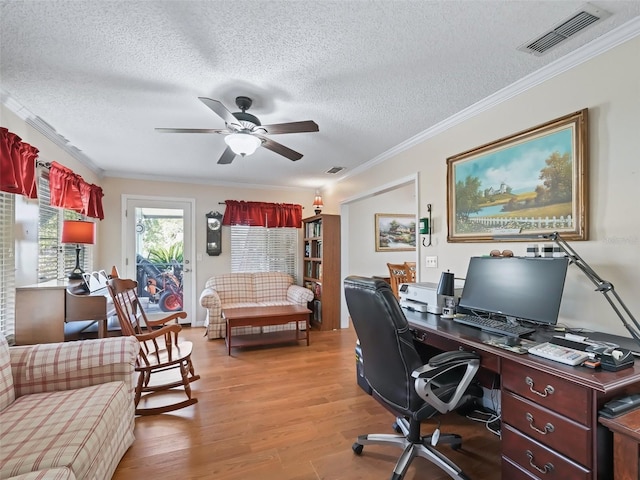 office with crown molding, light hardwood / wood-style flooring, a textured ceiling, and ceiling fan