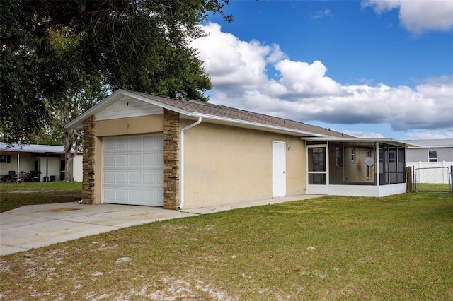 exterior space featuring a garage, a sunroom, and a front yard