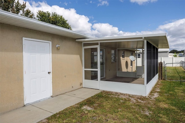 entrance to property featuring a lawn