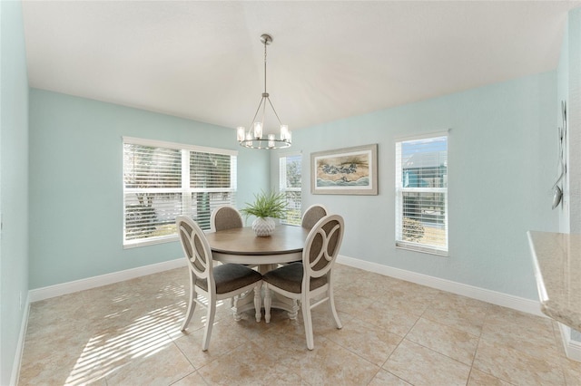 tiled dining space featuring a notable chandelier and plenty of natural light