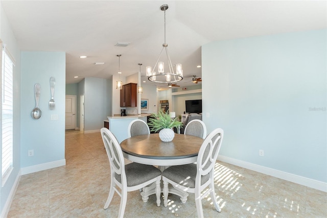 dining space with lofted ceiling, sink, and an inviting chandelier