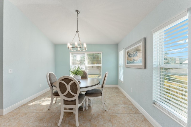 dining room featuring light tile patterned flooring and a chandelier