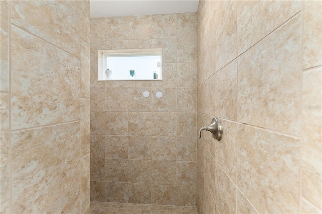 bathroom with tiled shower