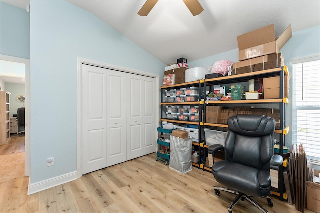 home office featuring ceiling fan, vaulted ceiling, and light wood-type flooring