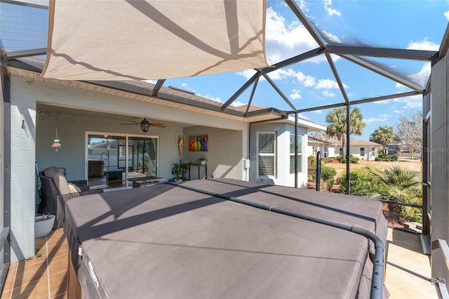 view of patio / terrace featuring ceiling fan and a lanai