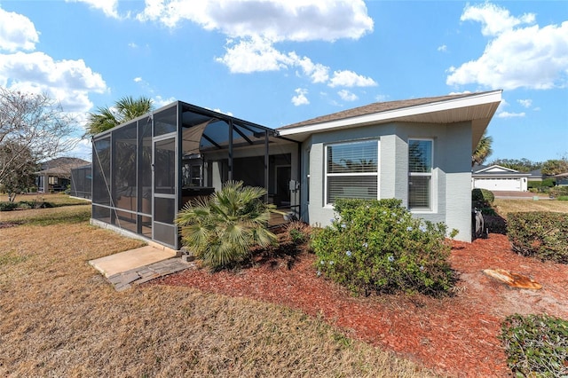 rear view of house featuring a yard and a lanai