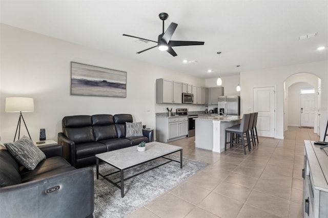 living room with light tile patterned flooring and ceiling fan