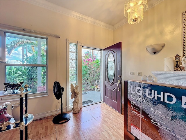 entryway featuring crown molding and an inviting chandelier