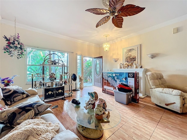 living room featuring ornamental molding, plenty of natural light, and ceiling fan with notable chandelier