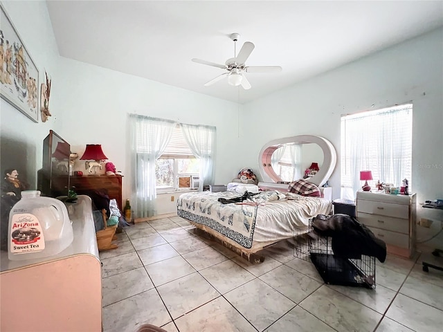 tiled bedroom featuring ceiling fan