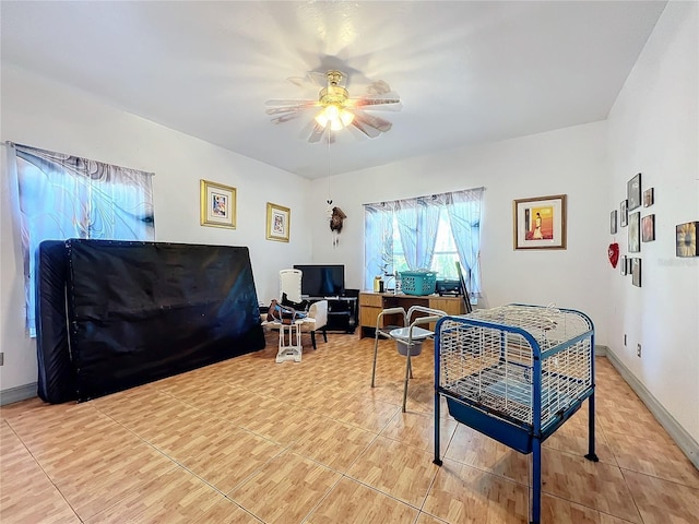 tiled office space featuring ceiling fan