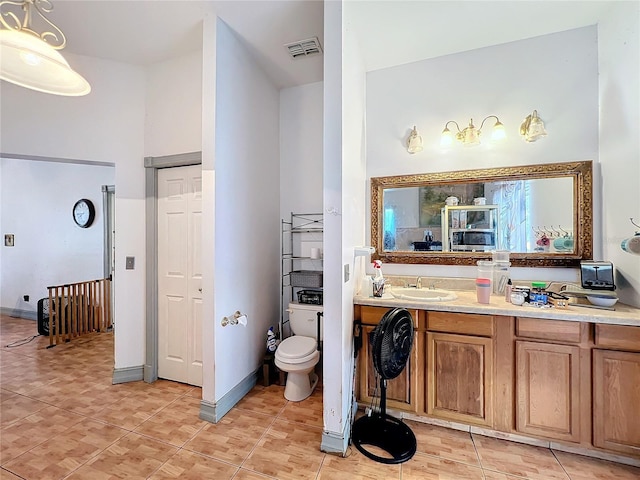 bathroom featuring tile patterned floors, toilet, and vanity