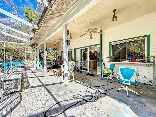 view of patio / terrace with a lanai and ceiling fan