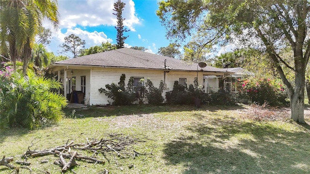 view of side of property with a lawn