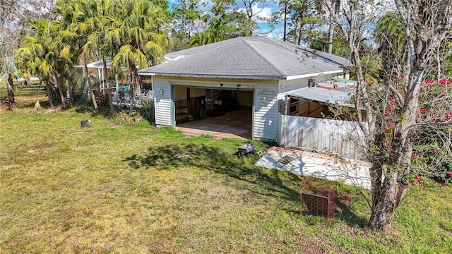 view of side of home with an outbuilding, a yard, and a garage