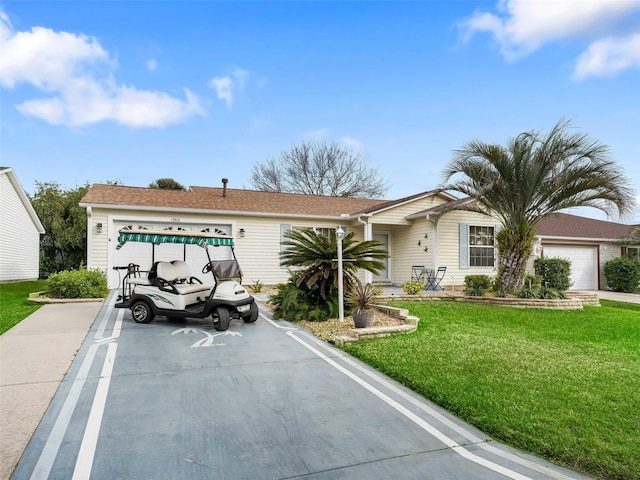 ranch-style house with a garage and a front yard