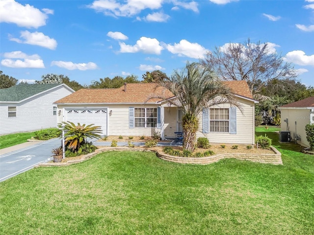 single story home with cooling unit, a garage, and a front yard