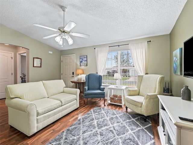 living room featuring lofted ceiling, a textured ceiling, dark wood-type flooring, and ceiling fan