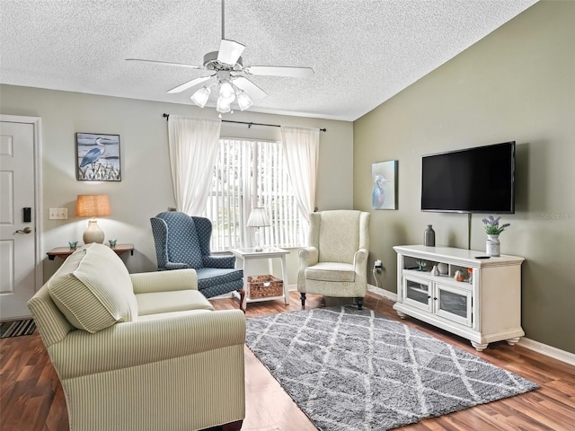 living room with a textured ceiling, wood-type flooring, and ceiling fan