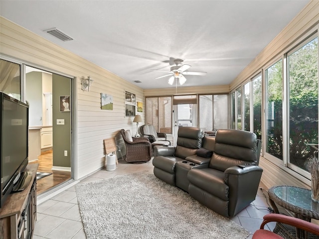 sunroom / solarium featuring ceiling fan