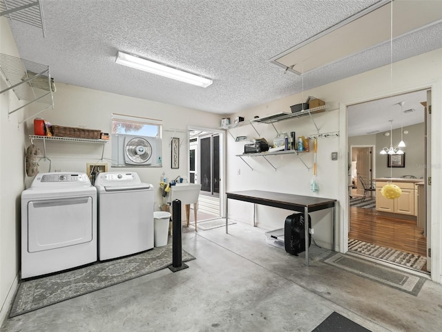 laundry room with separate washer and dryer and a textured ceiling