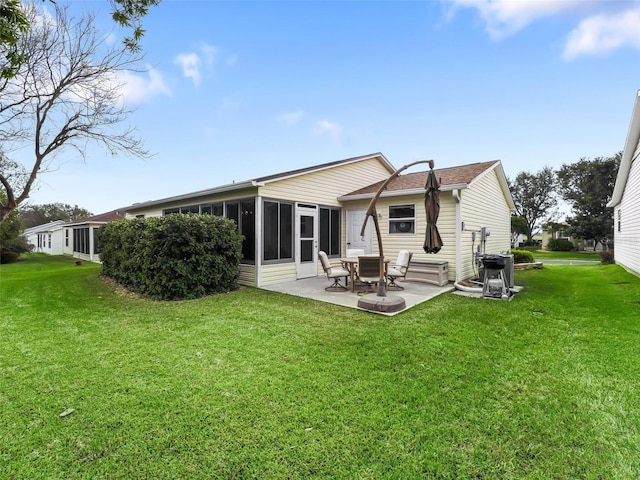 rear view of property with a patio, a sunroom, and a lawn