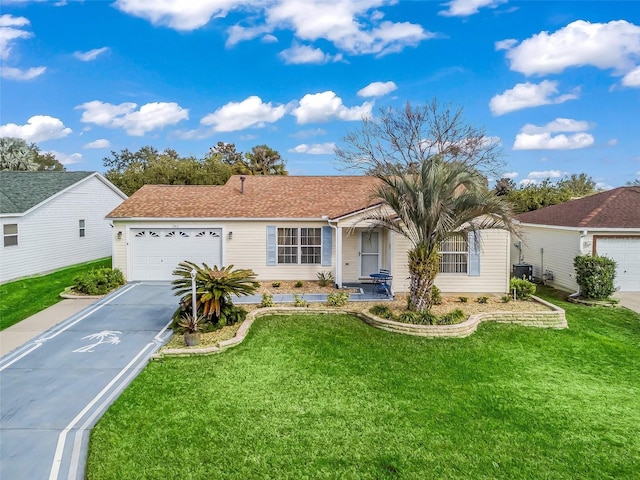 ranch-style house featuring a garage and a front lawn