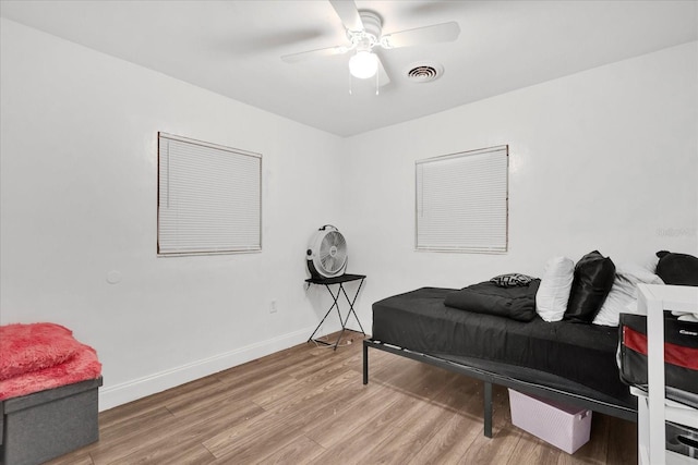 bedroom with hardwood / wood-style floors and ceiling fan