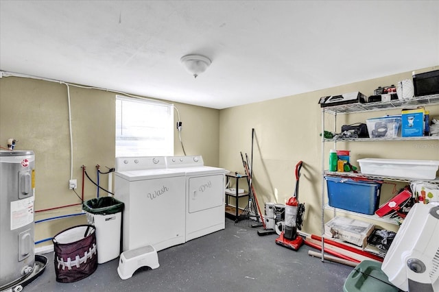 washroom with washing machine and dryer and water heater