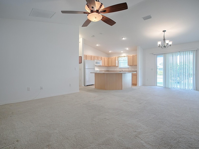 unfurnished living room featuring ceiling fan with notable chandelier, lofted ceiling, and light colored carpet