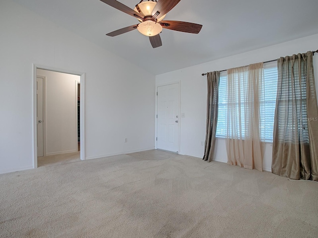 unfurnished bedroom featuring lofted ceiling, light colored carpet, a closet, and ceiling fan