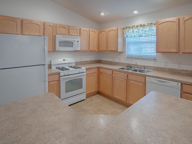 kitchen with vaulted ceiling, sink, light tile patterned floors, light brown cabinets, and white appliances