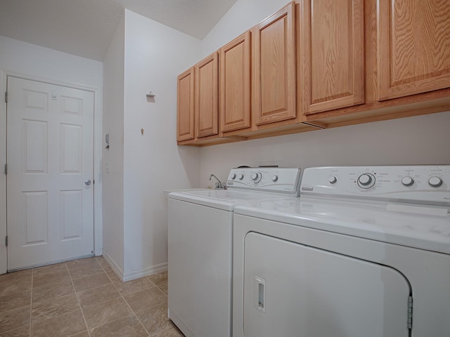 washroom featuring cabinets and separate washer and dryer