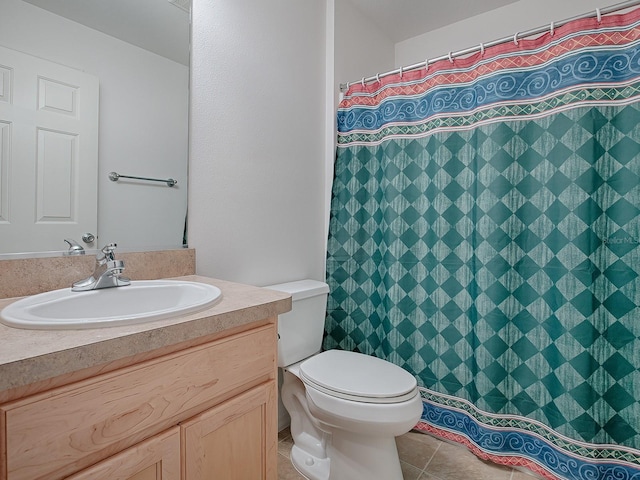 bathroom featuring vanity, tile patterned floors, and toilet