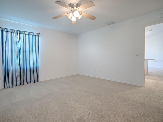 carpeted spare room with ceiling fan